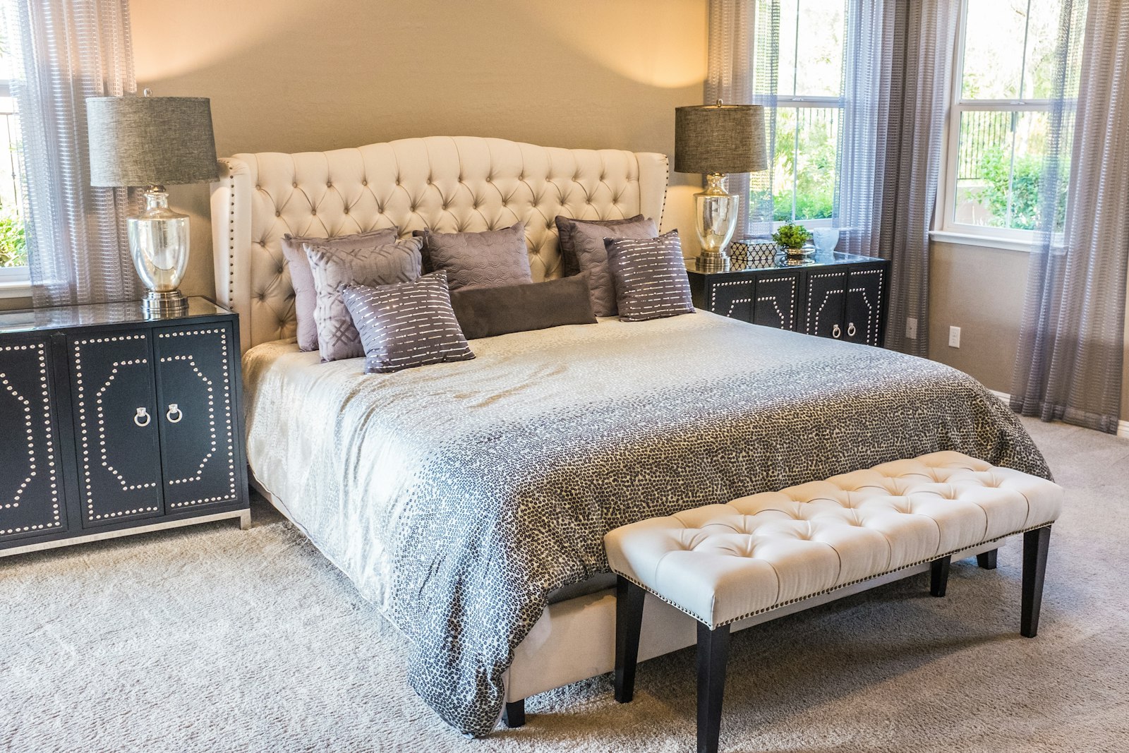 Made bed with white linen in a bright bedroom
